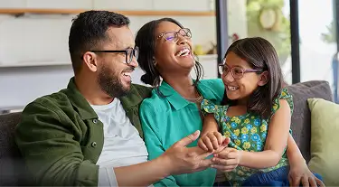 Family sitting on the couch and laughing